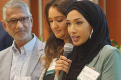 A woman from the Muslim Philanthropy Initiative speaks to an audience.